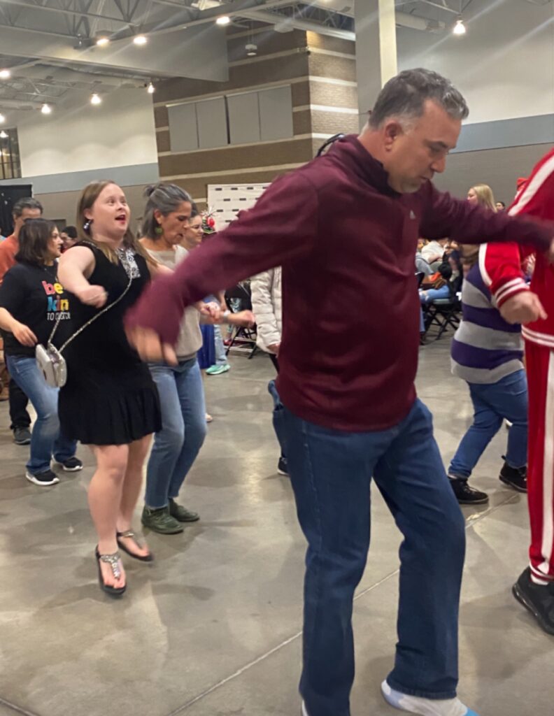 Paul Cunningham dancing with participants at Disability Pride Day